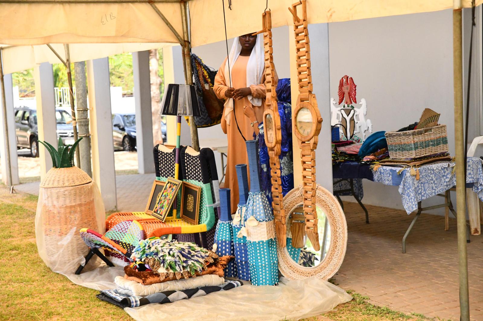 Exhibitor stand with woven baskets, fabrics and crafts at FESTMINT in Abuja